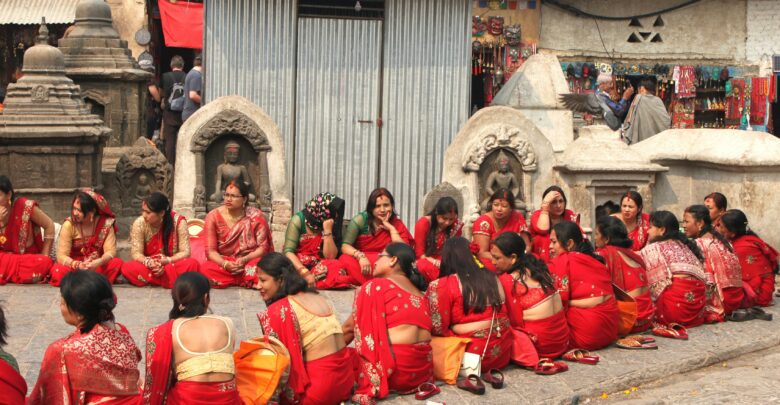 Group of Nepalese married women wearing red colored tradition attire gathered to celebrate Teej Festival